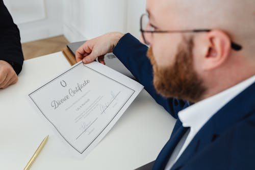 Man holding a finalized divorce decree.