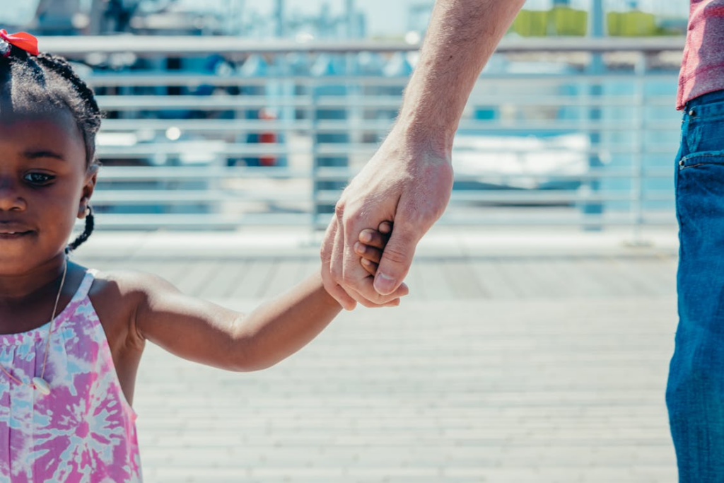 A child holding a parent’s hand