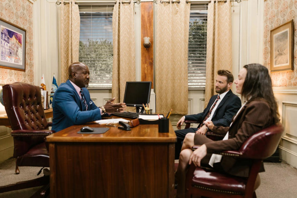 Family lawyer consulting with parents about custody and visitation arrangements in an office setting