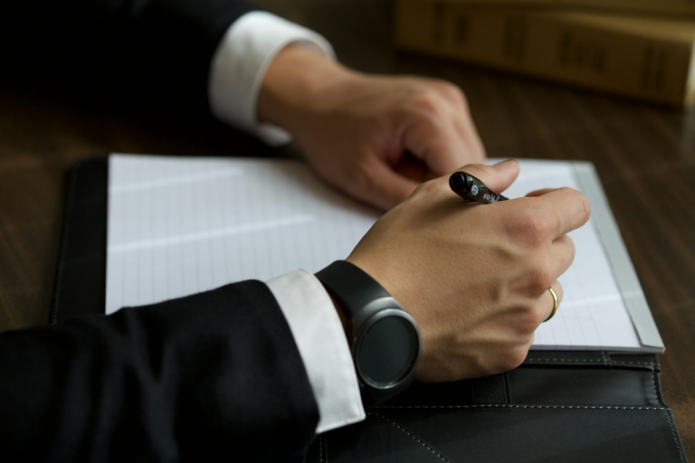 A person signing a legal agreement.