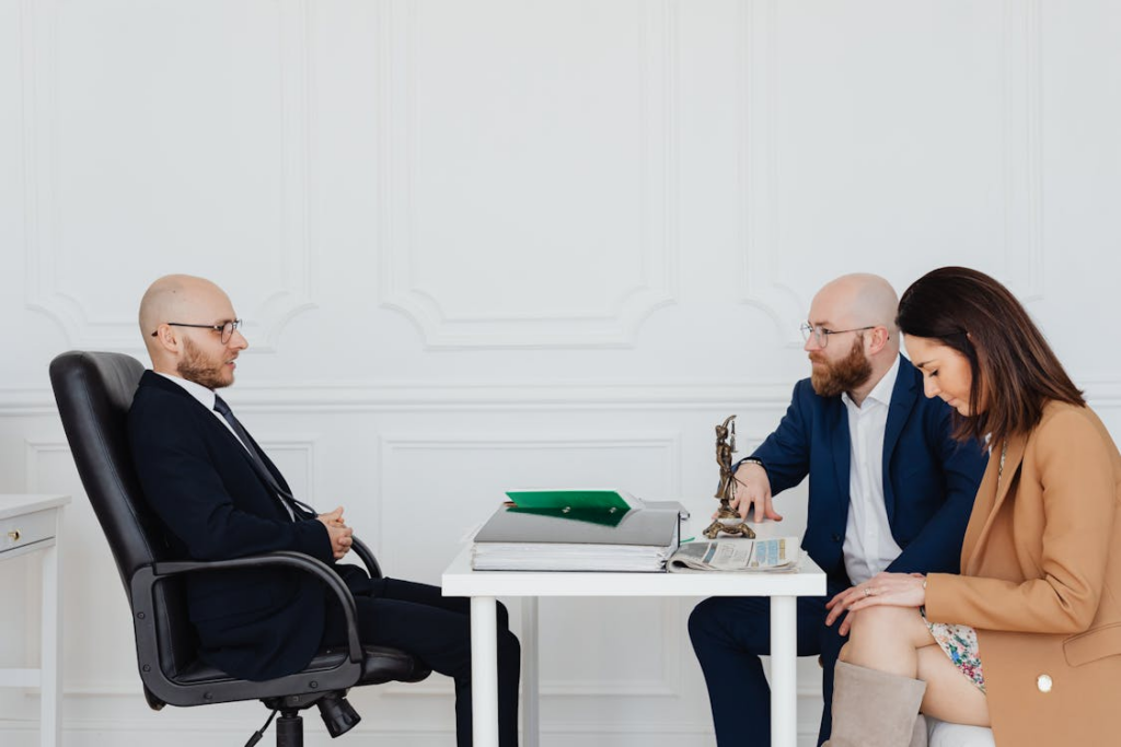 Divorced parents meeting separately with a lawyer to discuss a structured parenting plan