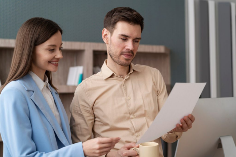 Two people looking at a piece of paper