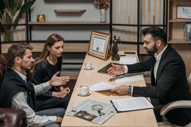 Family lawyers in Houston consulting with clients about complex domestic disputes in a professional office setting