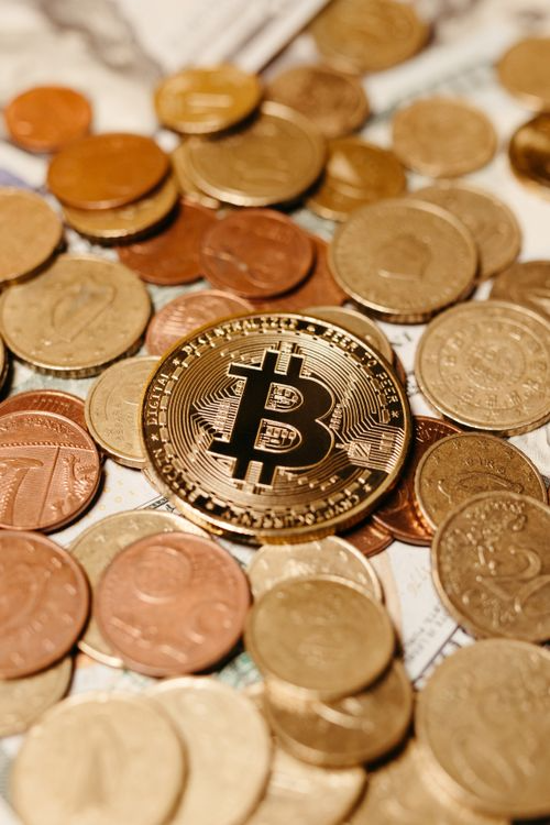 bitcoin logo on a golden coin on top of other golden coins