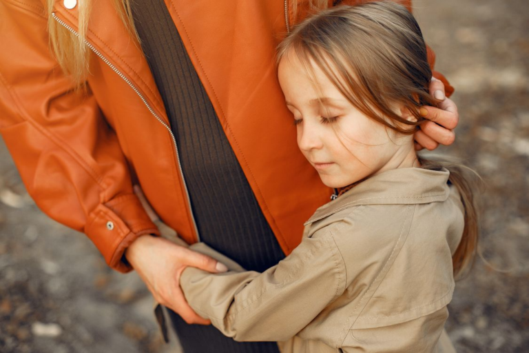 Child hugging parent for comfort