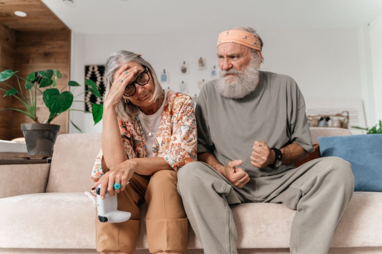 a frustrated couple sitting next to each other on the sofa