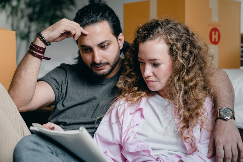 Couple discussing a prenuptial agreement with a lawyer in an office