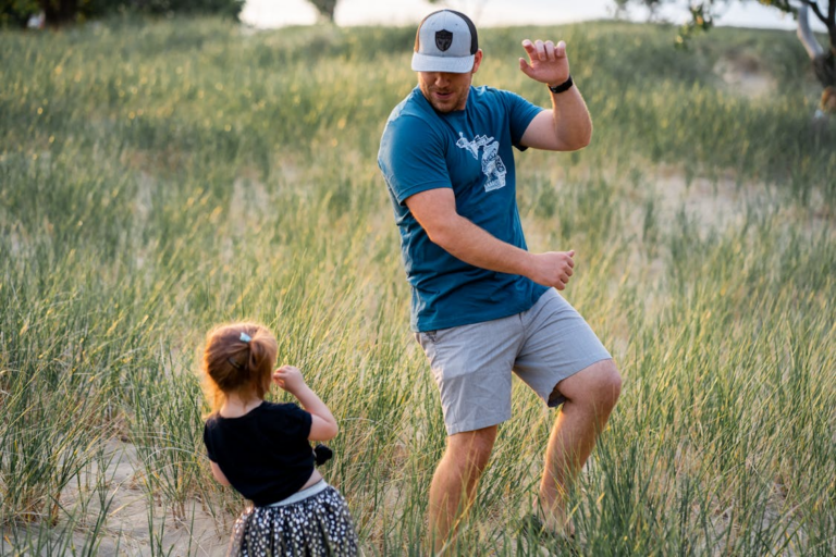 A father and daughter playing outside