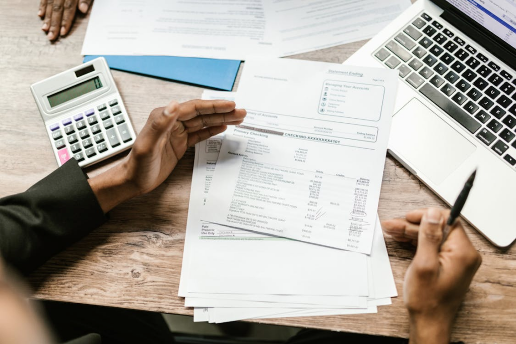Lawyer reviewing financial documents and income statements at a desk