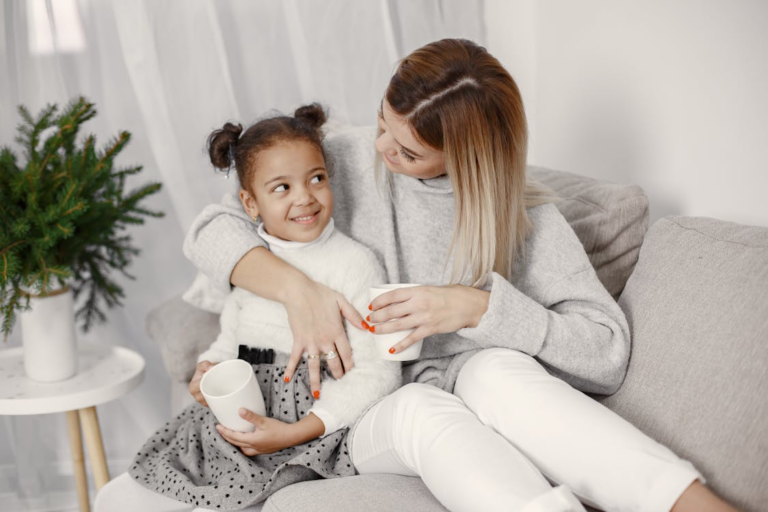 A parent and child cuddling on a couch
