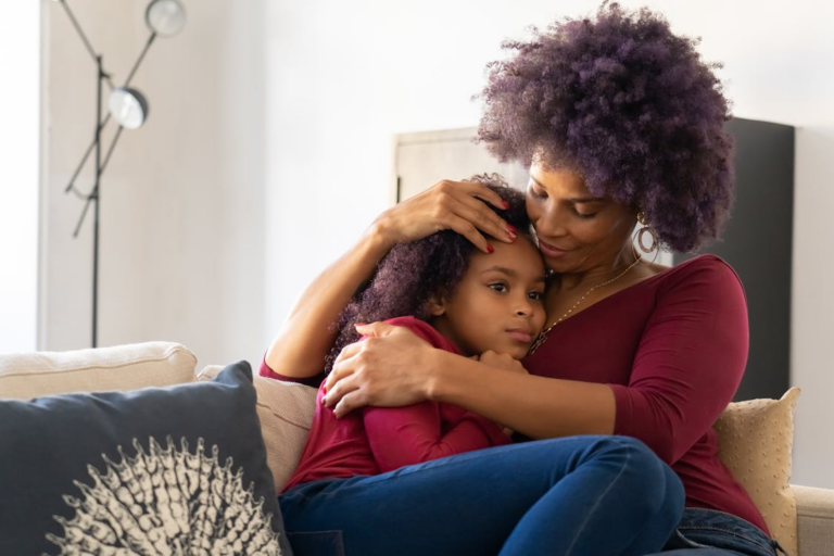A parent holding her daughter close