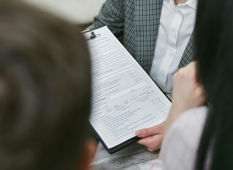 Couple reviewing financial documents while discussing a postnuptial agreement in Houston
