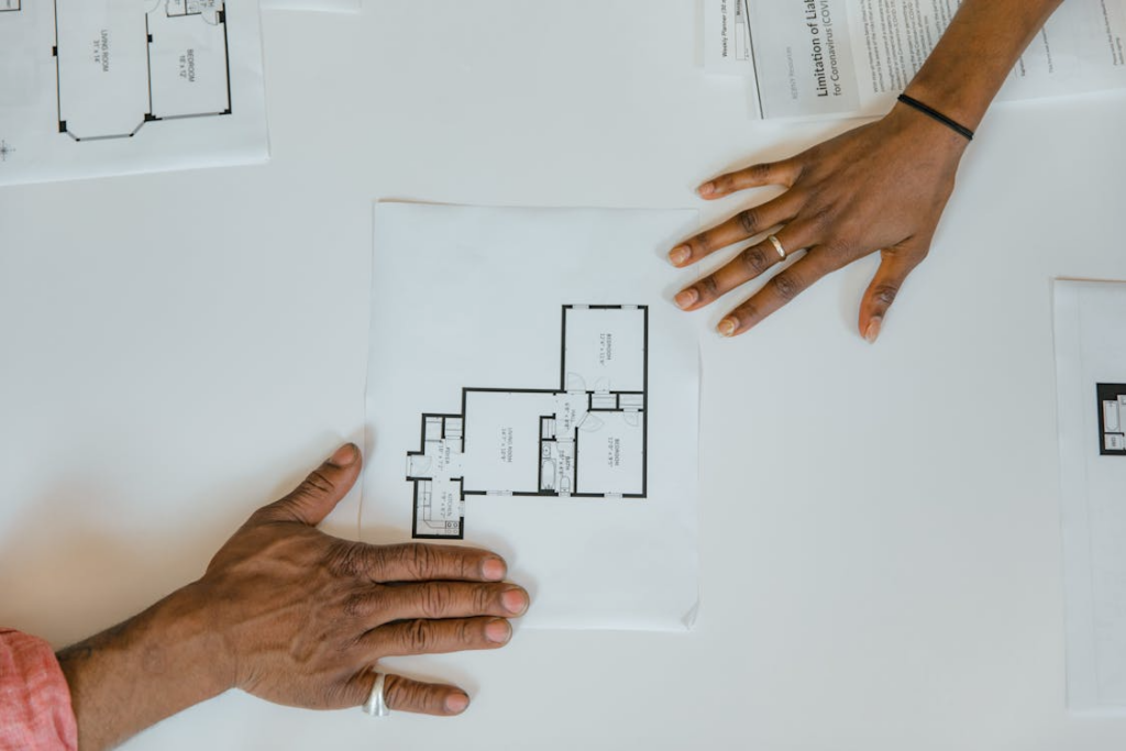 Hands reviewing a home floor plan