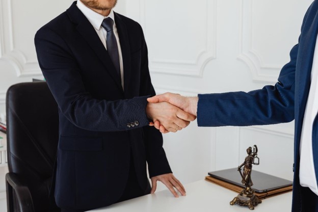 A lawyer shaking hands with a client