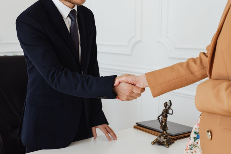 a lawyer and client shaking hands