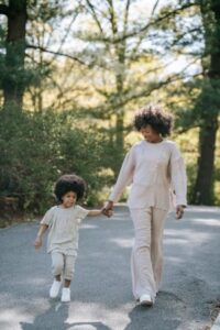 A mother and daughter walking in a park