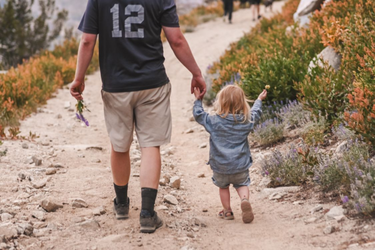 A parent and toddler on a trail