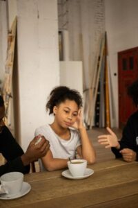 A child sitting with parents arguing