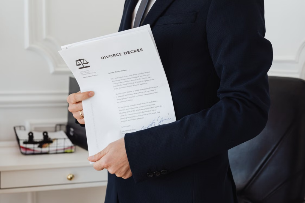 Person in a suit holding a document.