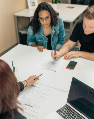 This image shows two clients reviewing legal documents during a consultation meeting.