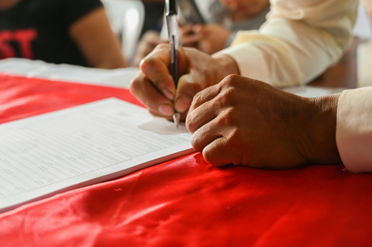 Couple signing a prenuptial agreement with their attorney