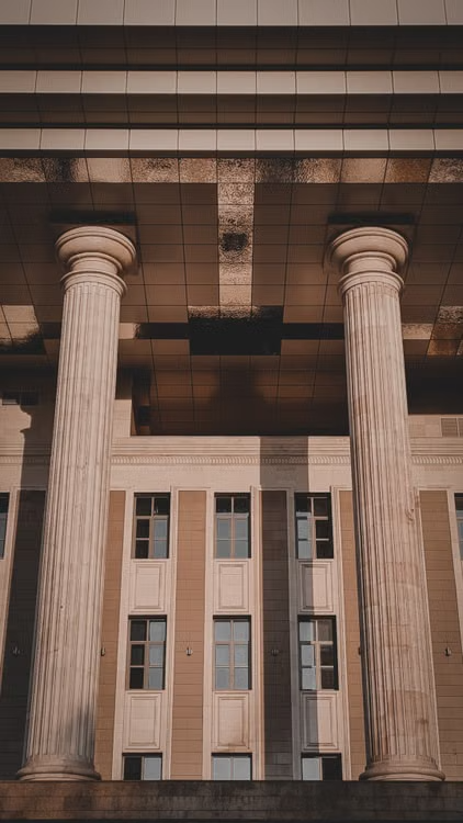 This image shows classical stone columns at the entrance of a courthouse building.