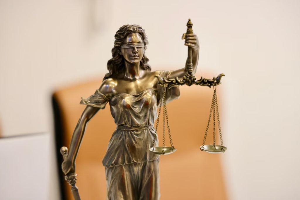 This image shows a close-up of a Lady Justice statue holding scales.