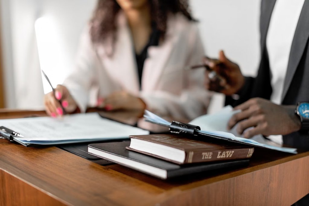 Attorneys reviewing law books and documents while preparing discovery for a contested divorce