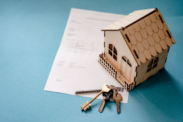 Miniature house model with keys and a contract representing a property division dispute