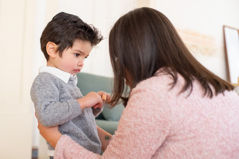 This image shows a mother having a calm, comforting conversation with her child indoors.