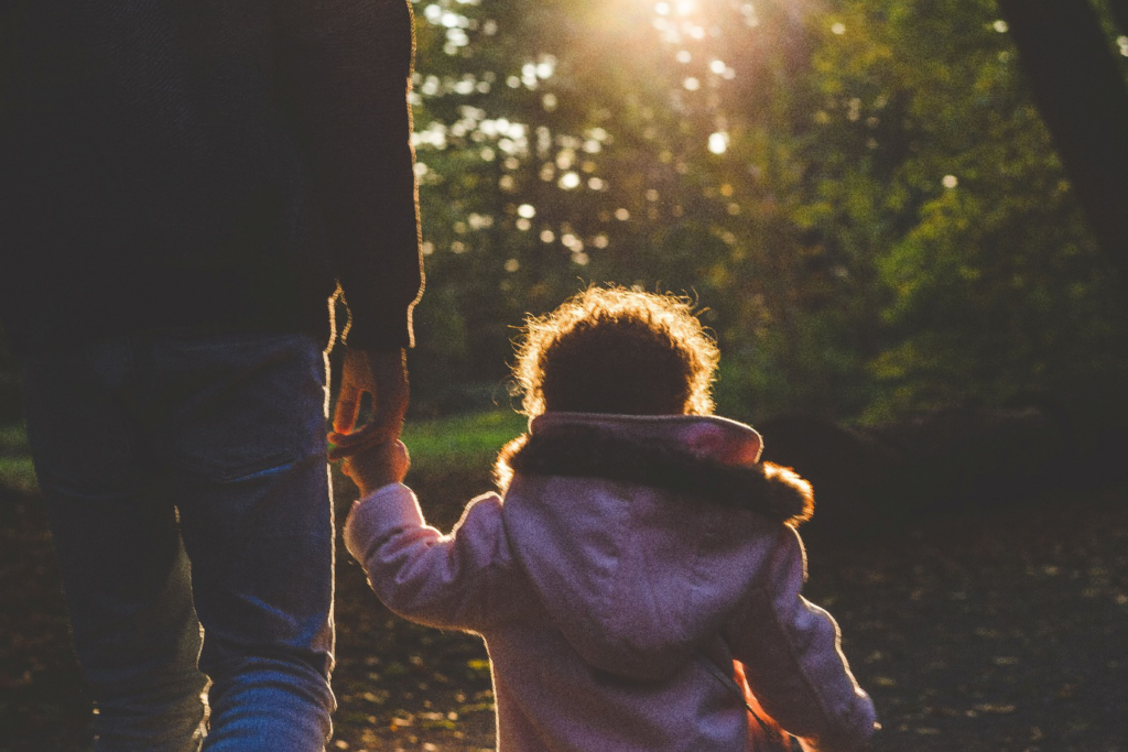 A child holding parent’s finger