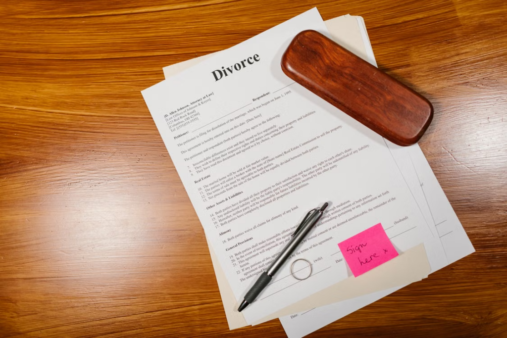 Divorce paperwork and pen representing contested and uncontested divorce in Texas