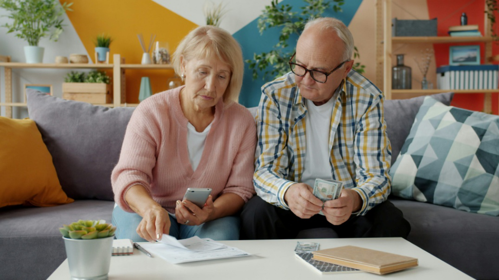 Older couple reviewing pension finances and retirement documents