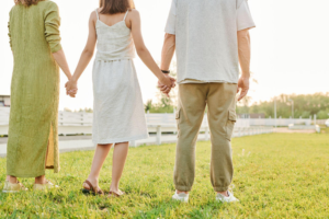 a child standing with her parents