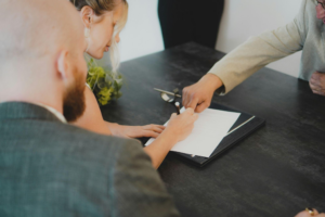 a divorced couple signing documents