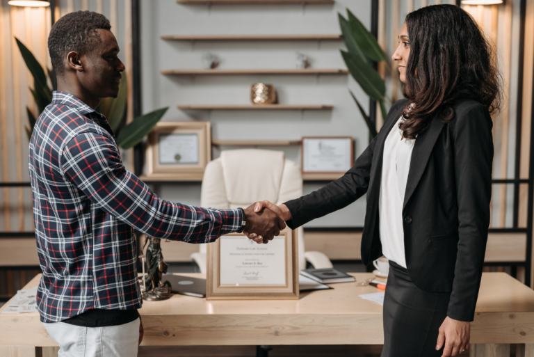 Man and woman shaking hands while reaching an agreement before divorce