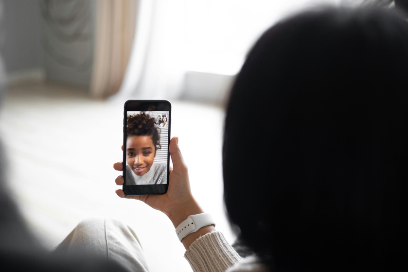 Parent video calling a child after moving to another city under a custody agreement