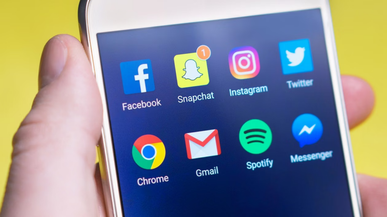 Person holding a smartphone displaying a social media feed