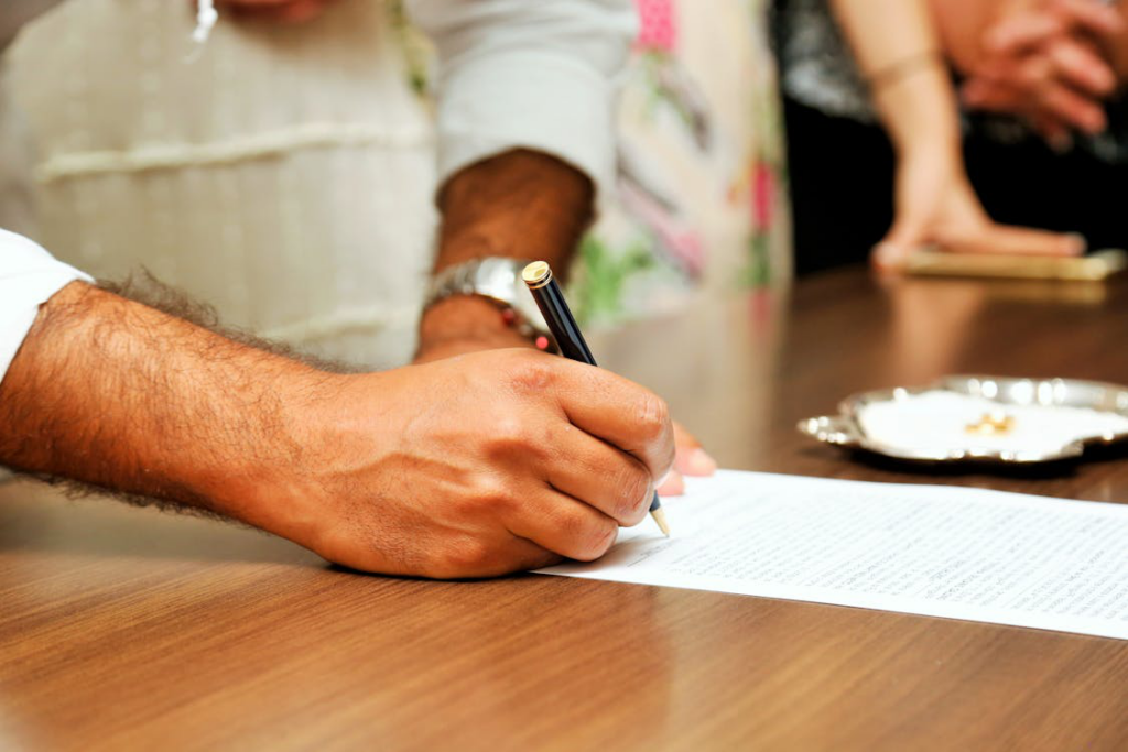 A person writing on white paper