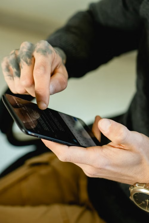 Person scrolling through a phone representing a common social media mistake during divorce