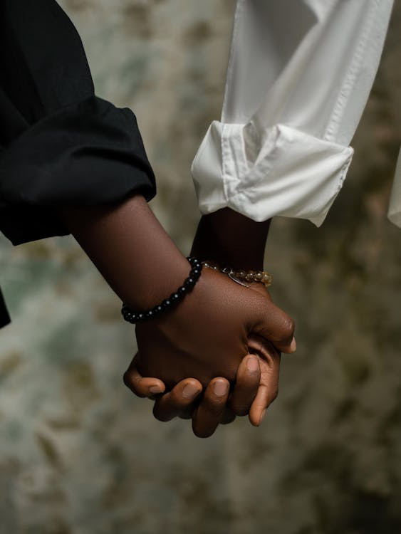 Two people holding hands