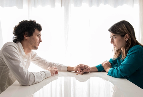 A man is holding a woman’s hand
