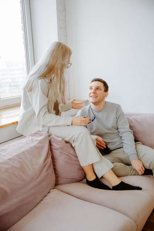 A couple having a calm conversation while sitting together on a couch